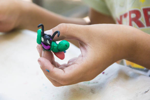 istock Child playing with colorful clay making animal figures. closeup on hands 1200947641