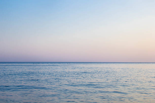 istock Calm Blue sea waves soft surface Ocean And Blue Sky Background 1200947644