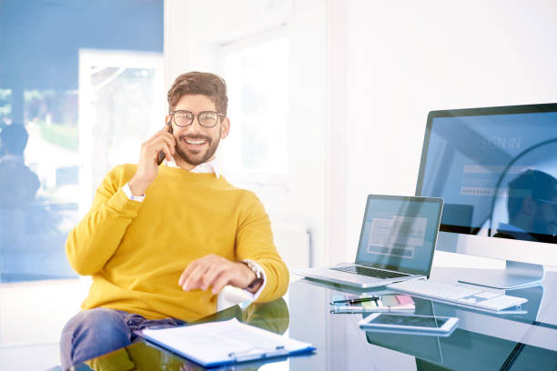 istock Businessman using mobile phone in the office and talking with somebody 1200947785