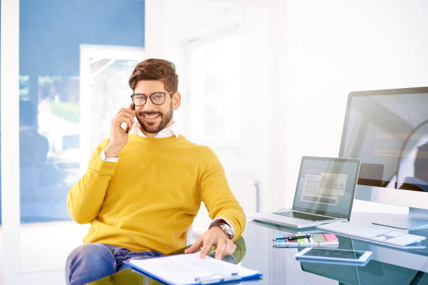 istock Businessman using mobile phone in the office and talking with somebody 1200947787