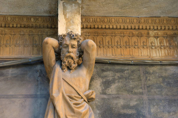 A statue of a bearded man supporting a great weight and acting as a column