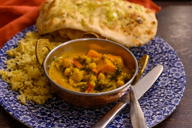 istock Mangalorean style roasted cauliflower and spinach curry with basmati rice and garlic naan bread, tasty vegetarian food 1200949128