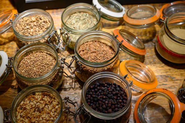 istock Tastes of gin, botanicals ingredients for gin distillery process, dried orange peels, juniper berries, heather, angelica, coriander, clove, cassia, liquorice 1200949143