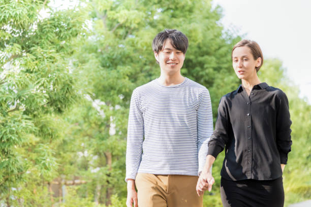 istock International couple walking (Western and Asians) 1200949568