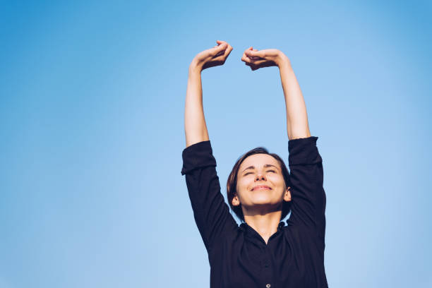 istock Woman relaxing under the blue sky 1200949617