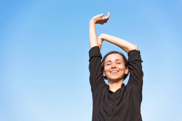 istock Woman relaxing under the blue sky 1200949647