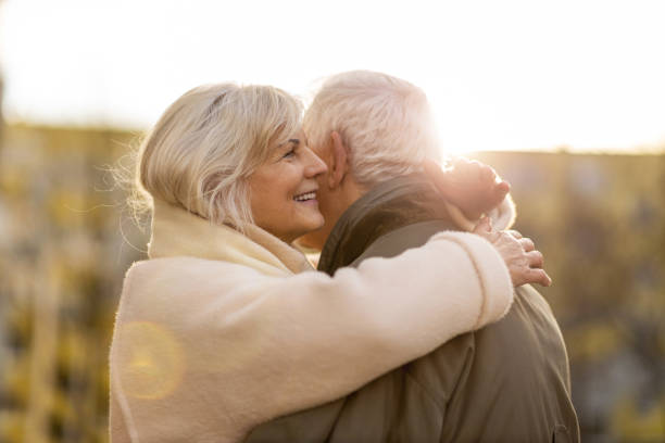 istock Senior couple hugging outdoors in autumn 1200949881