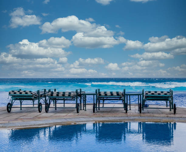 istock Four Chairs Reflected by the Sea 1200949951