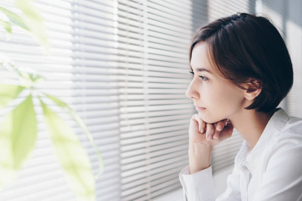 istock Woman looking out of window 1200950180