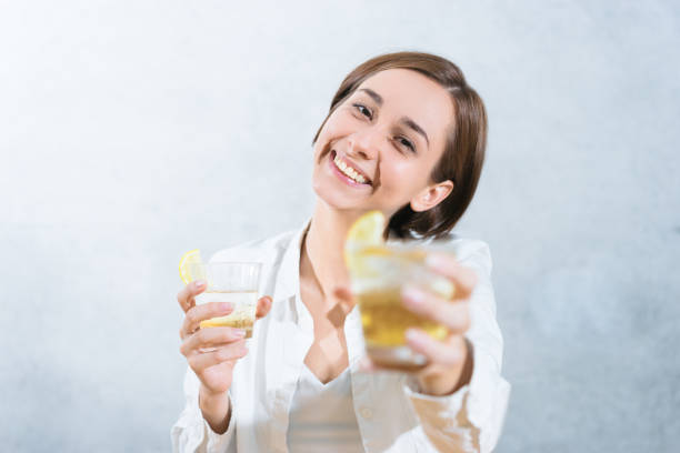 istock Woman handing a cocktail (image of a toast) 1200951125