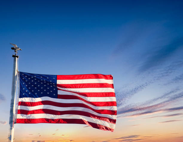 istock American Flag in the Wind at Dawn 1200951246
