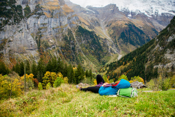 autumn season, young woman hiking  and take a rest in murren, Swiss