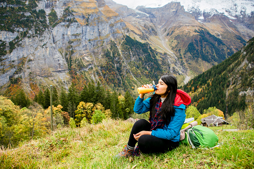 autumn season, young woman hiking  and take a rest in murren, Swiss