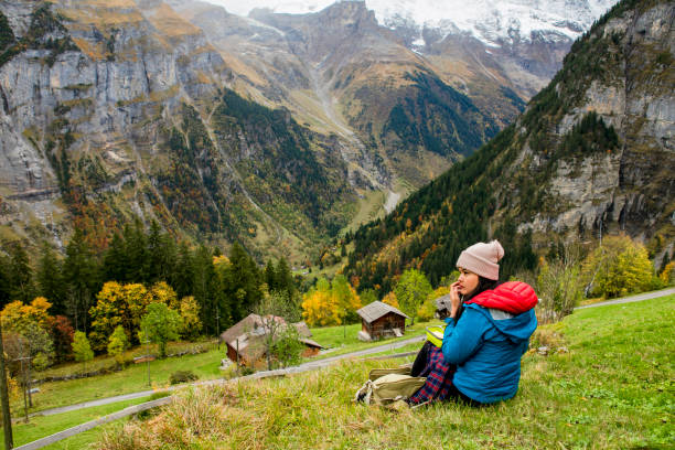 autumn season, young woman hiking  and take a rest in murren, Swiss