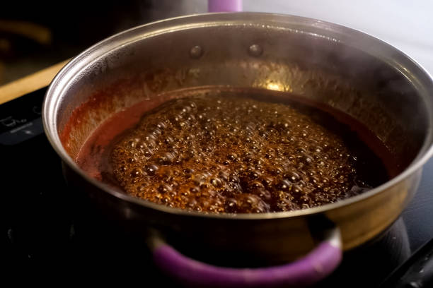 istock Boiling jam, jam to jam. boiling on fire in steel plate. 1200953748
