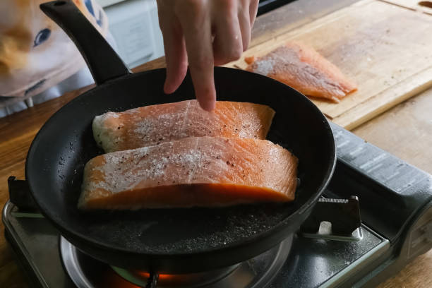 Frying red fish in pan. Pieces of red fish. stock photo