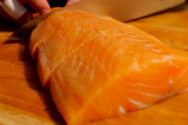 istock slicing red fish on the board. Pieces of red 1200953815