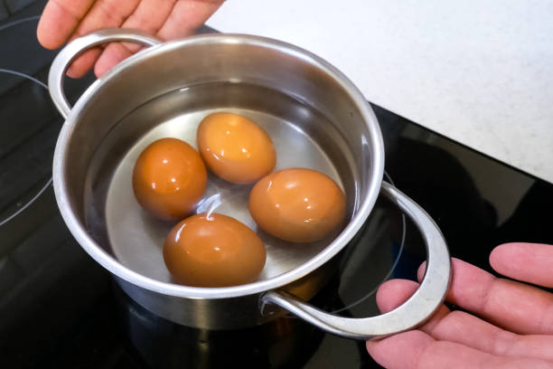 istock Boiled eggs in pan are removed from the stove. 1200953945