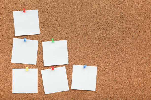 istock cork board with white empty notes of paper  with copy space 1200954211