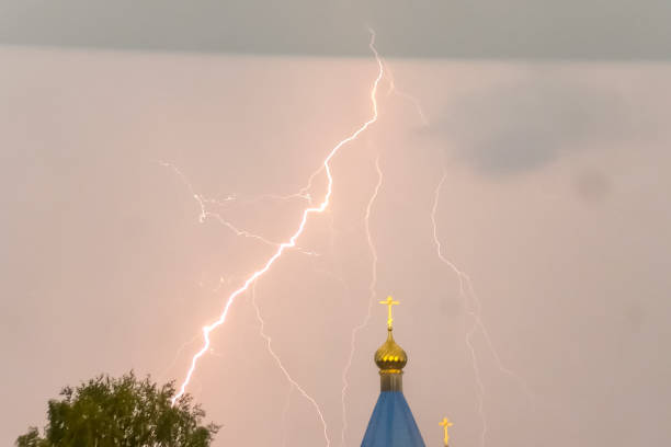 Thunderstorm with lightning in the night sky over the village.
