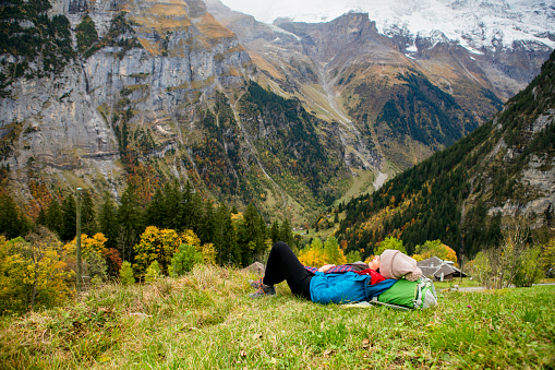 autumn season, young woman hiking  and take a rest in murren, Swiss