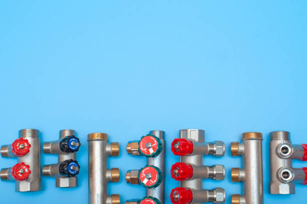 istock Adjusting manifolds for water supply and heating, blue background, copy space 1200957765