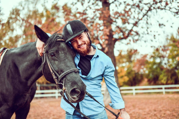 istock Male Embracing Horse On Ranch 1200963816