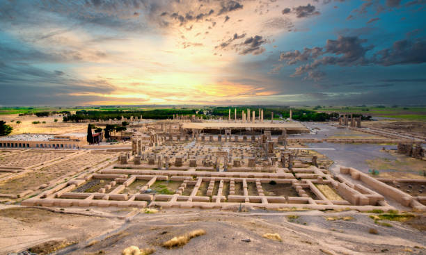 The ruins of the acient city Persepolis at sunset, Iran The ruins of the acient city Persepolis at sunset, Iran.  Persepolis (Old Persian: Pārśa; Modern Persian: Pārse) was the ceremonial capital of the Achaemenid Empire (ca. 550–330 BC). The site is situated 60 km northeast of the city of Shiraz in Fars Province, Iran. The earliest remains of Persepolis date back to 515 BC. It exemplifies the Achaemenid style of architecture and is an UNESCO World Heritage Site. shiraz stock pictures, royalty-free photos & images