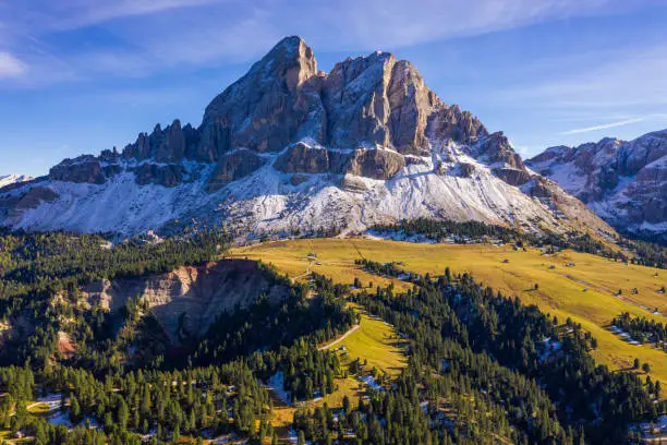 Stunning view of Peitlerkofel mountain from Passo delle Erbe in Dolomites, Italy. View of Sass de Putia (Peitlerkofel) at Passo delle Erbe, with wooden farm houses, Dolomites, South Tyrol, Italy.