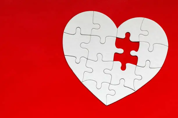 Heart object made of puzzle pieces. Make complete heart. Jigsaw puzzle pieces in form of heart. Happy Valentines Day, greeting card template. Heart jigsaw puzzle.