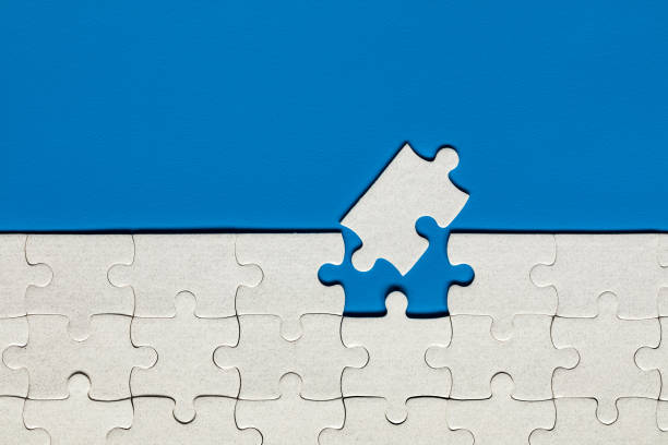 istock Closeup of jigsaw puzzle isolated. Missing jigsaw puzzle piece, business concept for completing the puzzle piece. Group of puzzle and a puzzle piece. Teamwork concept. Think difference concept. 1200967472