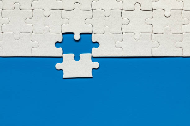 istock White jigsaw puzzle. White puzzle pieces on color background. Unfinished white jigsaw puzzle pieces on color background. 1200967483