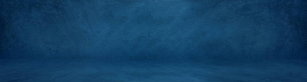 istock wide horizontal dark blue cement studio background to present product 1200968855
