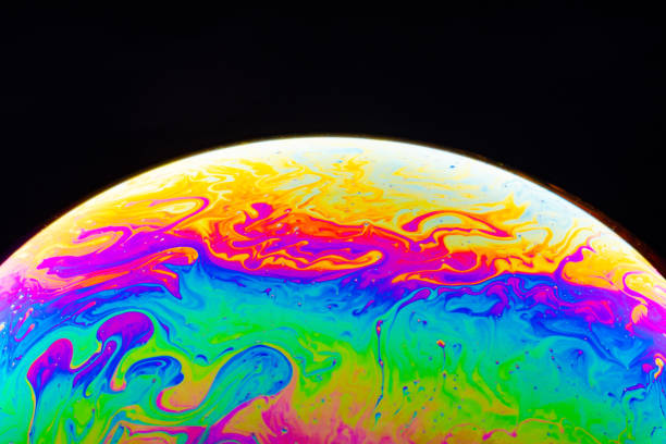 istock Macro shot of a soap bubble hemisphere. Abstract colorful liquid background. 1200969171