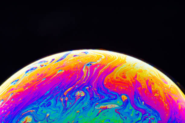 Macro shot of a soap bubble hemisphere. Abstract colorful liquid background. Soap bubble closeup. Abstraction background with bright acid colors. marble globe stock pictures, royalty-free photos & images