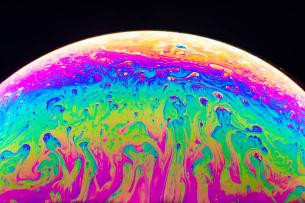 istock Macro shot of a soap bubble hemisphere. Abstract colorful liquid background. 1200969189
