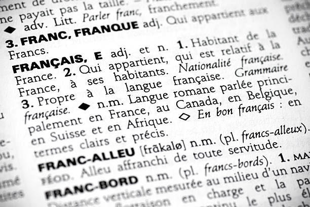 Français in the dictionary Macro shot with focus on the word français and its definition in a french dictionary. orthographic symbol stock pictures, royalty-free photos & images