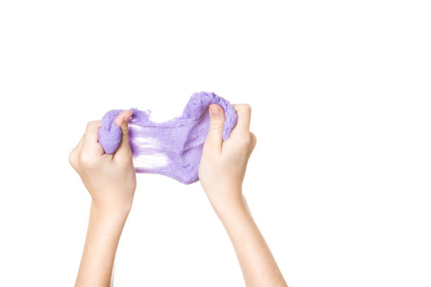 istock Stretched lilac slime in hands isolated on a white background. 1200969334