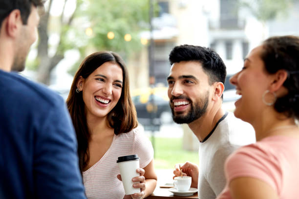istock Happy friends spending leisure time in coffee shop 1200971538