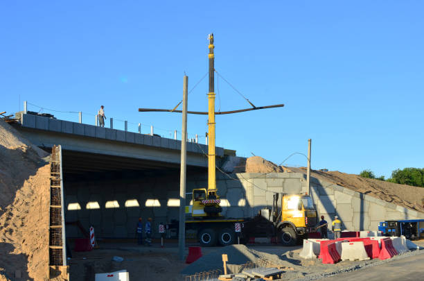 istock Mobile crane lifts the load on the construction site. 1200972455