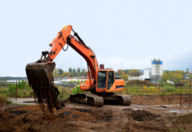 istock Excavator digs the ground for the foundation and construction of a new building. 1200972716