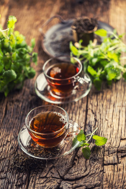 istock A cup of melissa tea with herbs on wooden table 1200972801