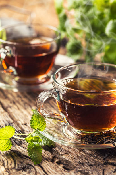 istock A cup of melissa tea with herbs on wooden table 1200972807