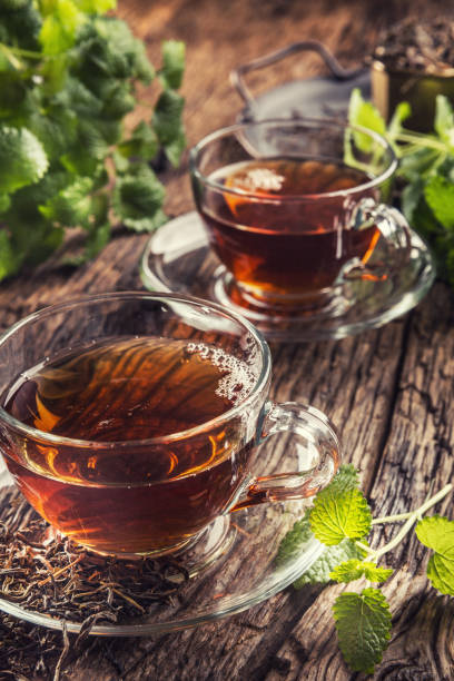 istock A cup of melissa tea with herbs on wooden table 1200972828
