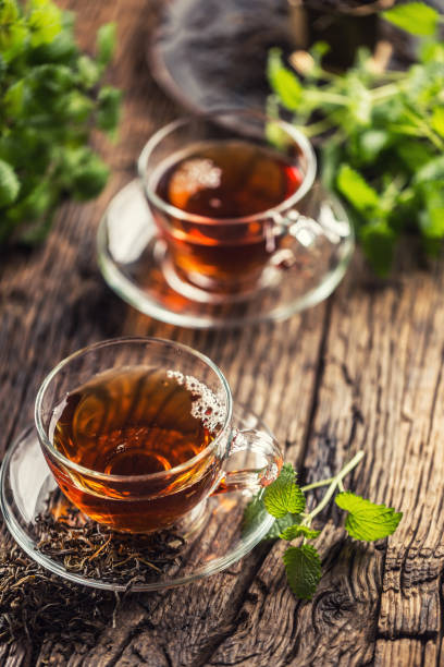 istock A cup of melissa tea with herbs on wooden table 1200972916