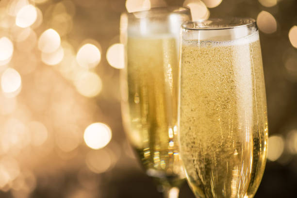 Closeup of champagne glass on a bokeh light background Closeup of two champagne glass on a bokeh light background. Happy celebration of New Year. PROSECCO stock pictures, royalty-free photos & images