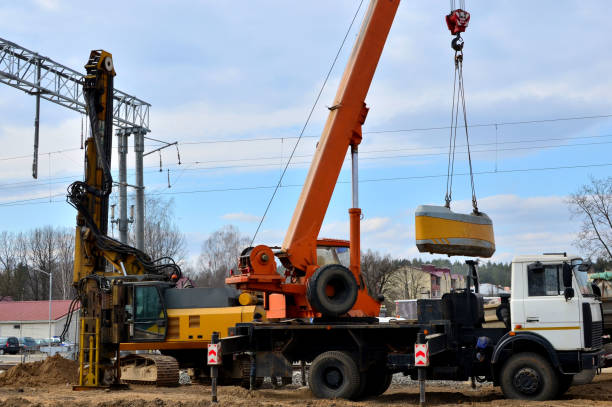 istock Foundation piles drilling machine and mobile crane on the construction cite on railway 1200973330