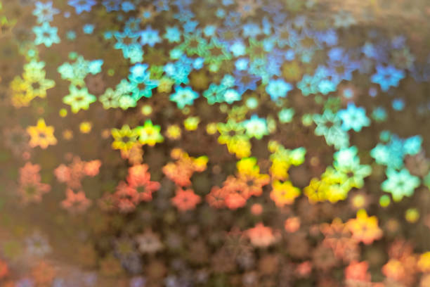 istock Holographic background with abstract colorful blur stars shaped bokeh 1200973615