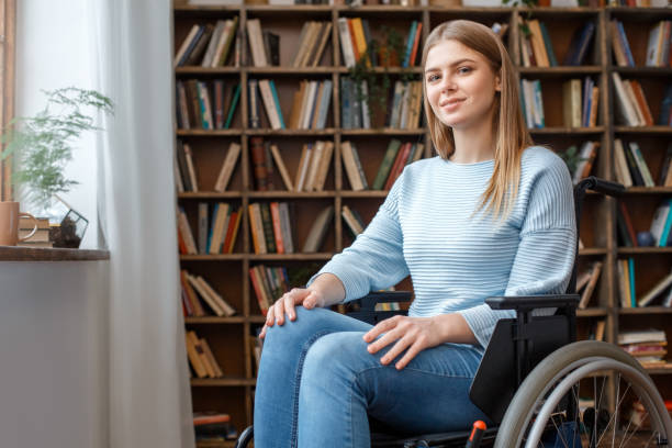 Young woman sitting in a wheelchair disability concept stock photo