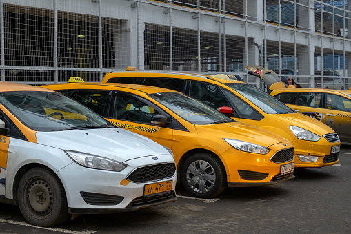 December 13, Moscow, Russia-row of yellow cars Yandex taxi